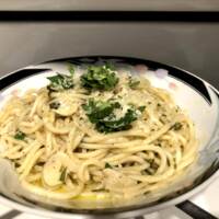 A picture of pasta in a bowl. This pasta is pasta agli o olio with parsley and garlic mixed in