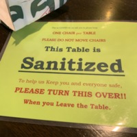 Laminated notice that table its resting on is either Sanitized or in need of cleaning
