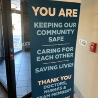 A stand up large print sign celebrating the workers at St. Luke's for saving lives and keeping the community safe
