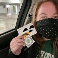 Image of Out of State student holding up vaccination record card and accompanying stickers