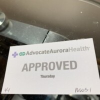 A small paper card ,around business card size, that says "approved" on it along with the day of the week it was issued, and what entrance it was issued from at St Luke's.