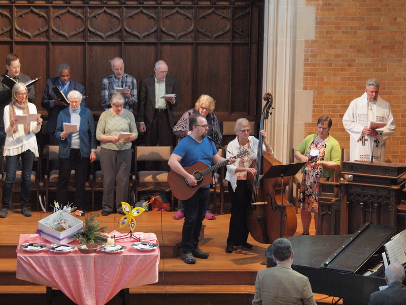 Photograph of the choir and musicians of Plymouth Church performing at Sunday service.