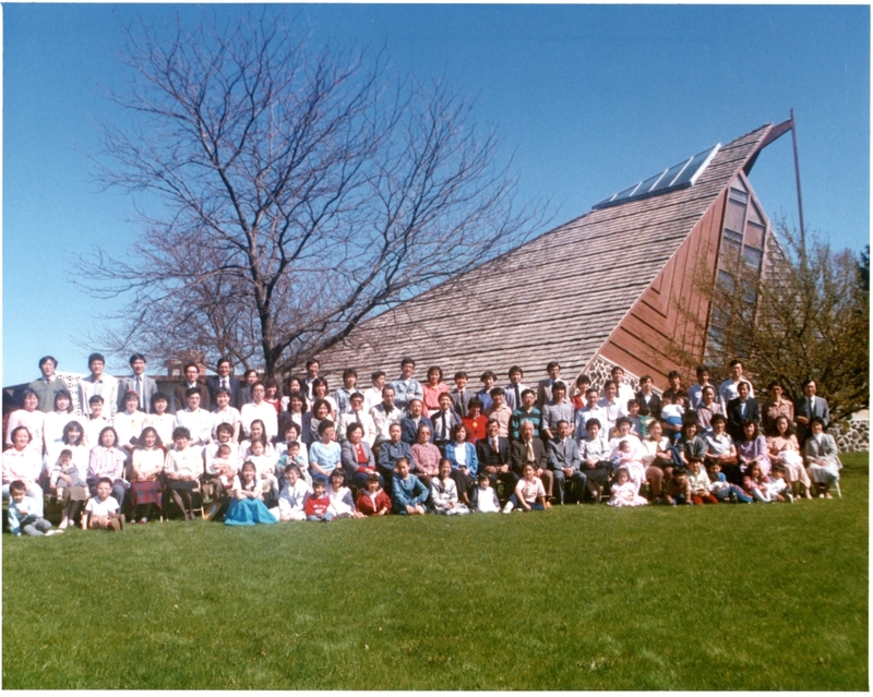 Historical photograph of the CCCM congregation in front of Trinity Community Church, 1988.