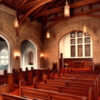 Photo of Chapel's interior enameled brick walls and oak millwork pews and ceiling.