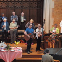 Photograph of the choir and musicians of Plymouth Church performing at Sunday service.