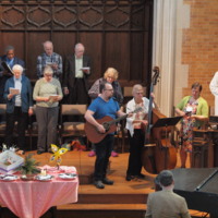 Modern photograph of the musicians and choir of Plymouth Church performing at the Sunday service on April 29, 2018.