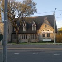 Photograph showing the exterior the of First Unitarian Church's third church. A banner stating "Black Lives Matter" is hung from the exterior.